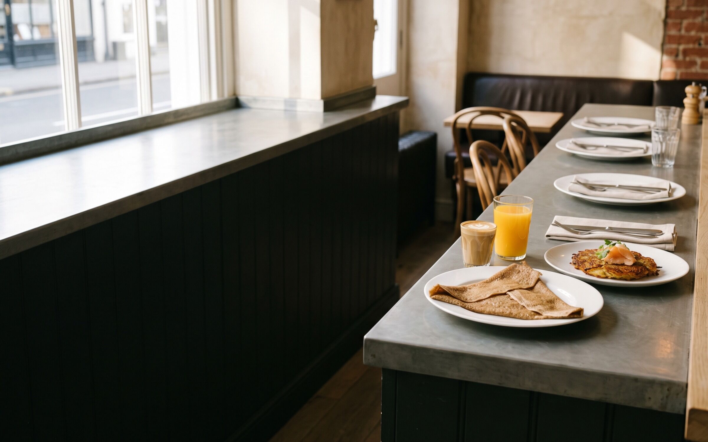 A buckwheat crêpe, smoked-trout rösti and orange juice at a crowded end of the counter