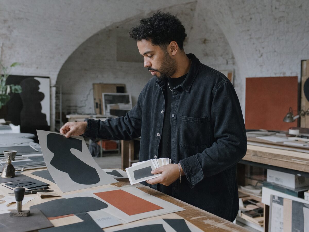 Callum Reid handling cut letterform shapes and blank storyboard cards in the Foundry studio